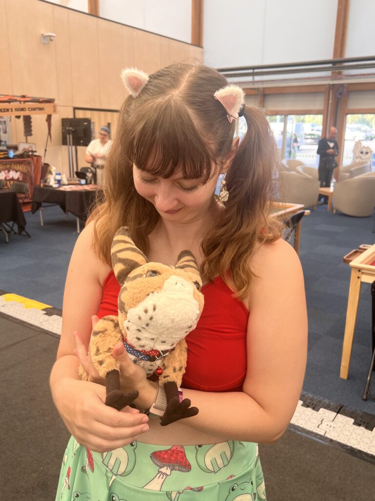 woman holding animatronic loth cat at Canterbury gaming convention