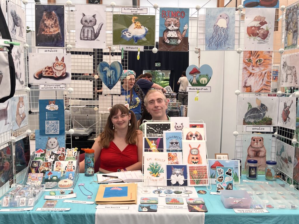 stall at canterbury gaming convention with cute animal art