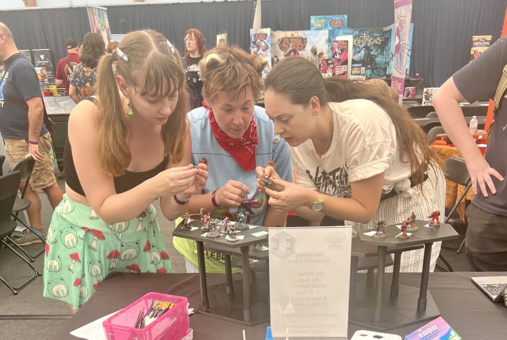 artists judging a miniature painting competition